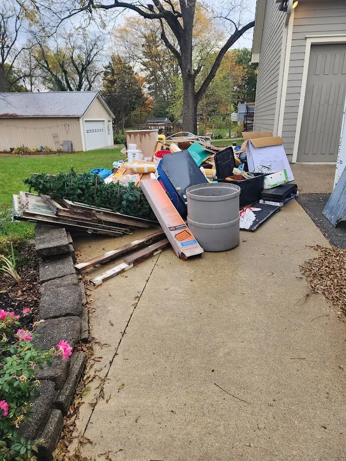 Dumpster being loaded with debris for 12 Yard Dumpster Rental in Keene